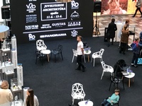 LED screen in the shopping center, gray carpeting, tables and chairs