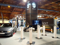 At the car exhibition, a stand made of black structures was built, with a tower standing at the back